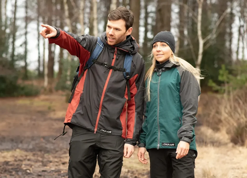 Couple walking in a forest pointing