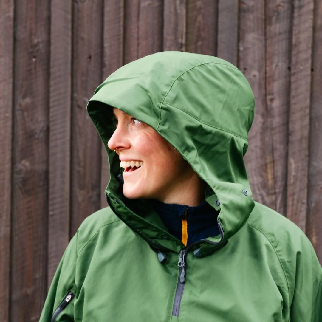Smiling woman in a green waterproof hood