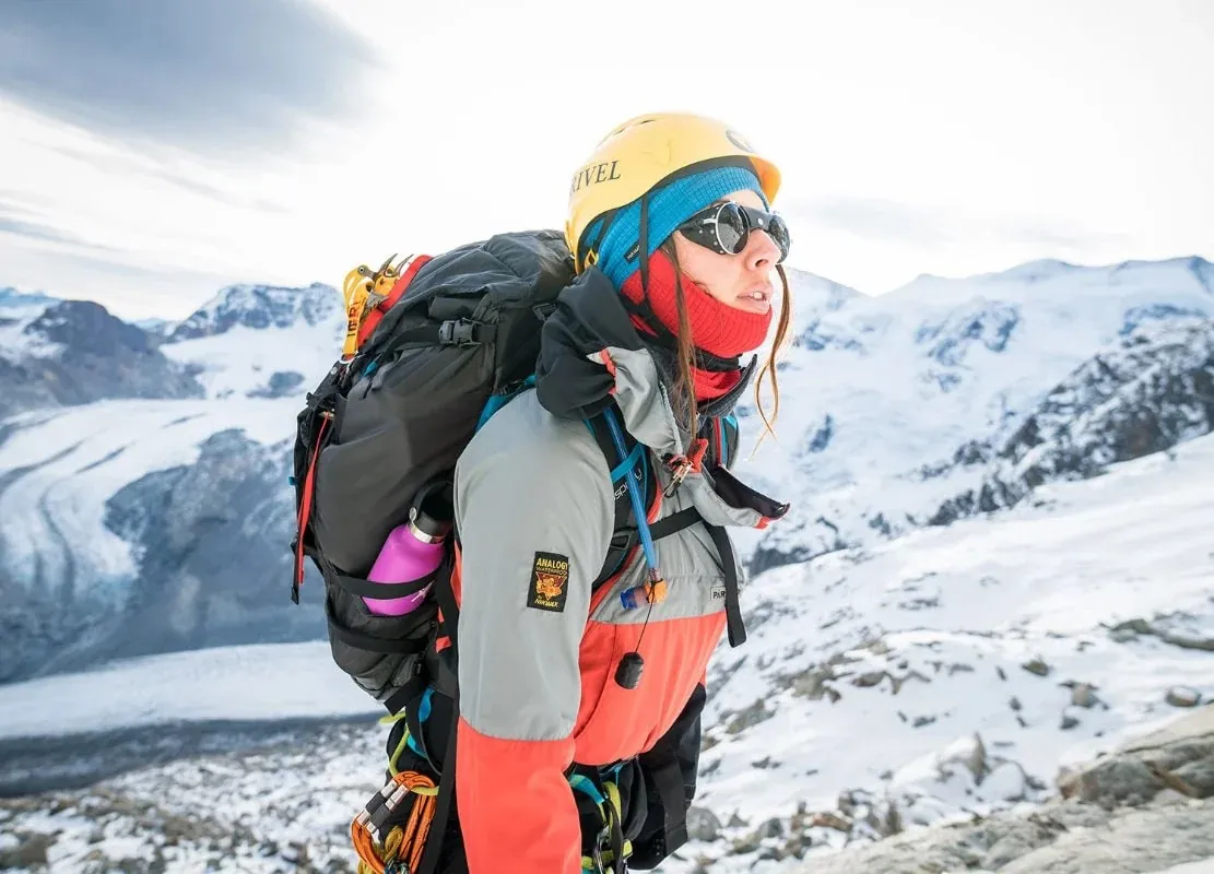 Mountaineer in a yellow helmet on a glacier