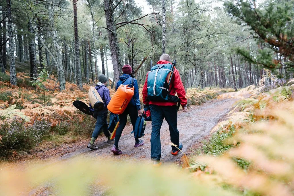 Walkers on a forest trail wearing Páramo waterproofs