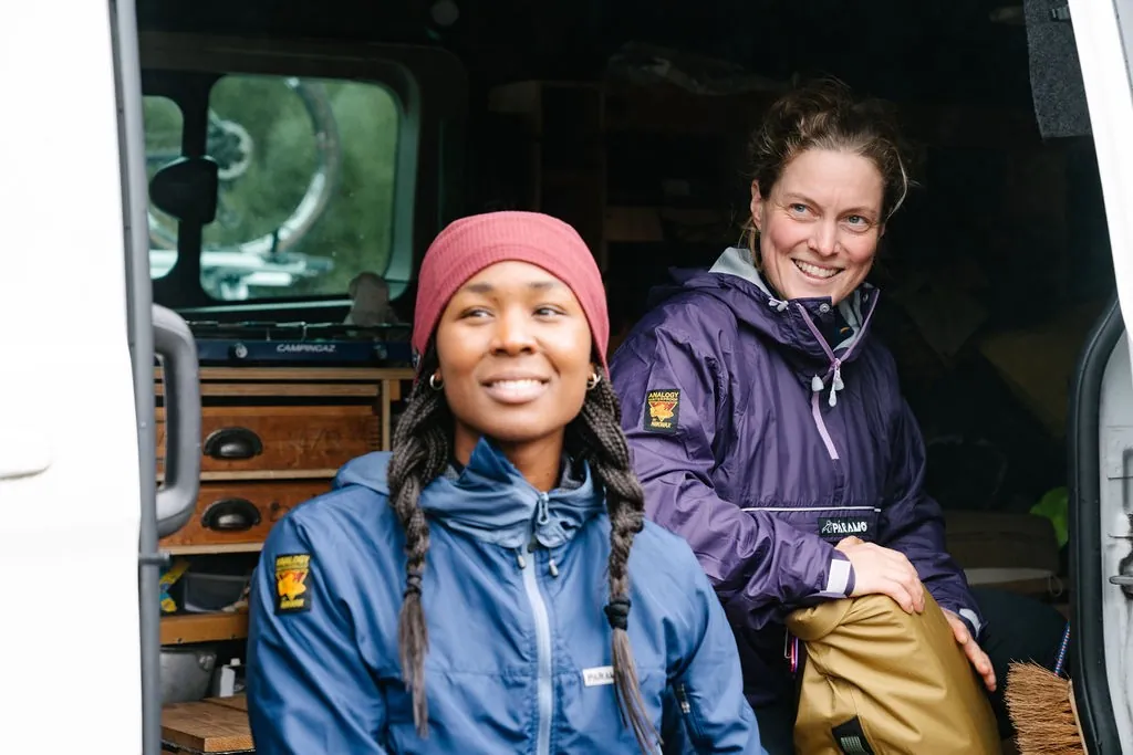 Two women in Páramo jackets sitting in a campervan